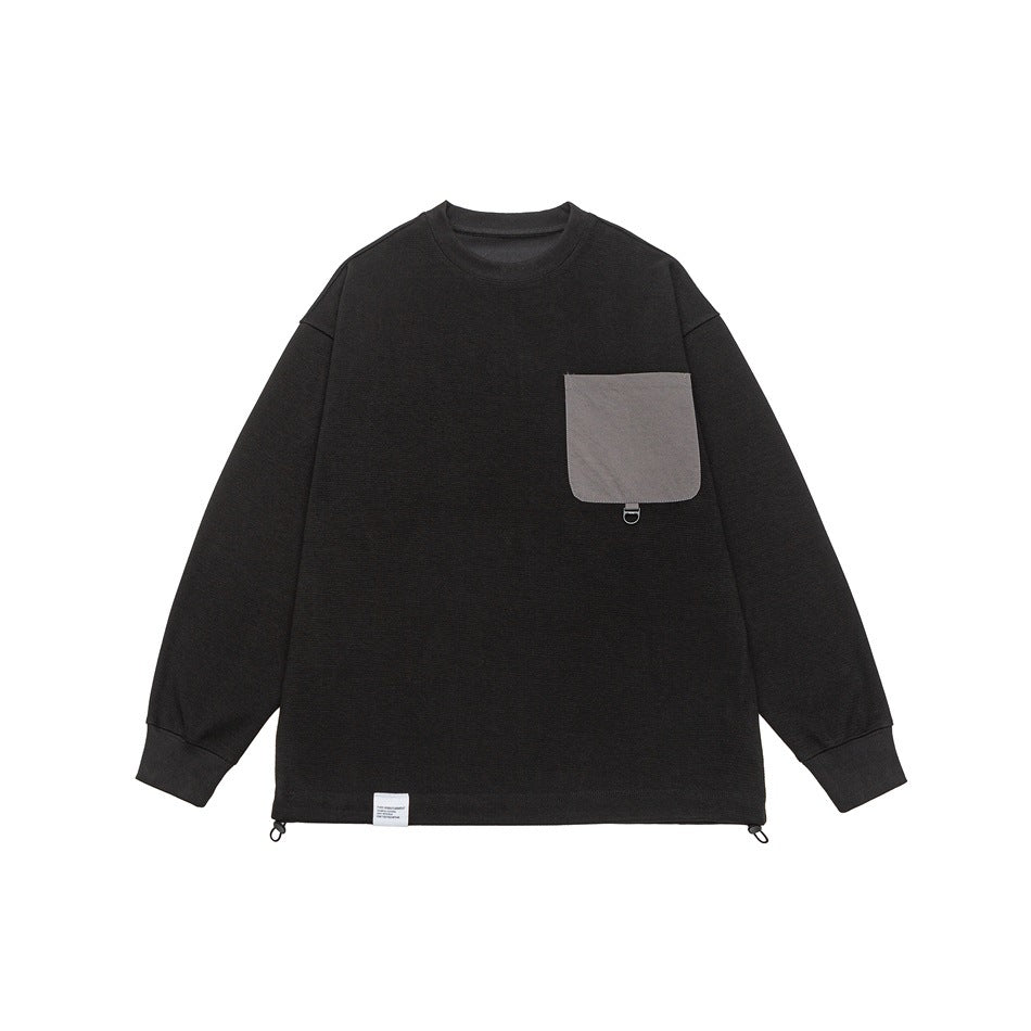 Black crewneck sweatshirt flat lay with gray chest flap pocket, ribbed cuffs and drawcord hem