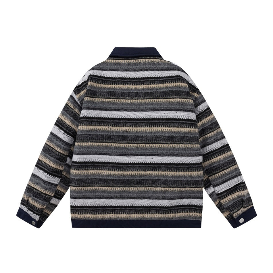 Back view of navy jacket with horizontal gray, black, cream and beige stripes and snap cuffs