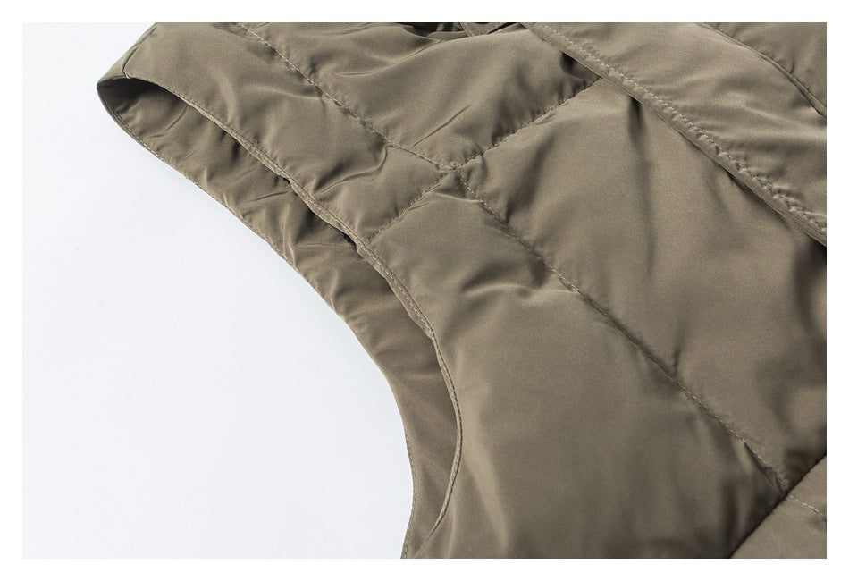 Close-up of the vest's bound armhole edge and quilted stitching in olive-khaki fabric.
