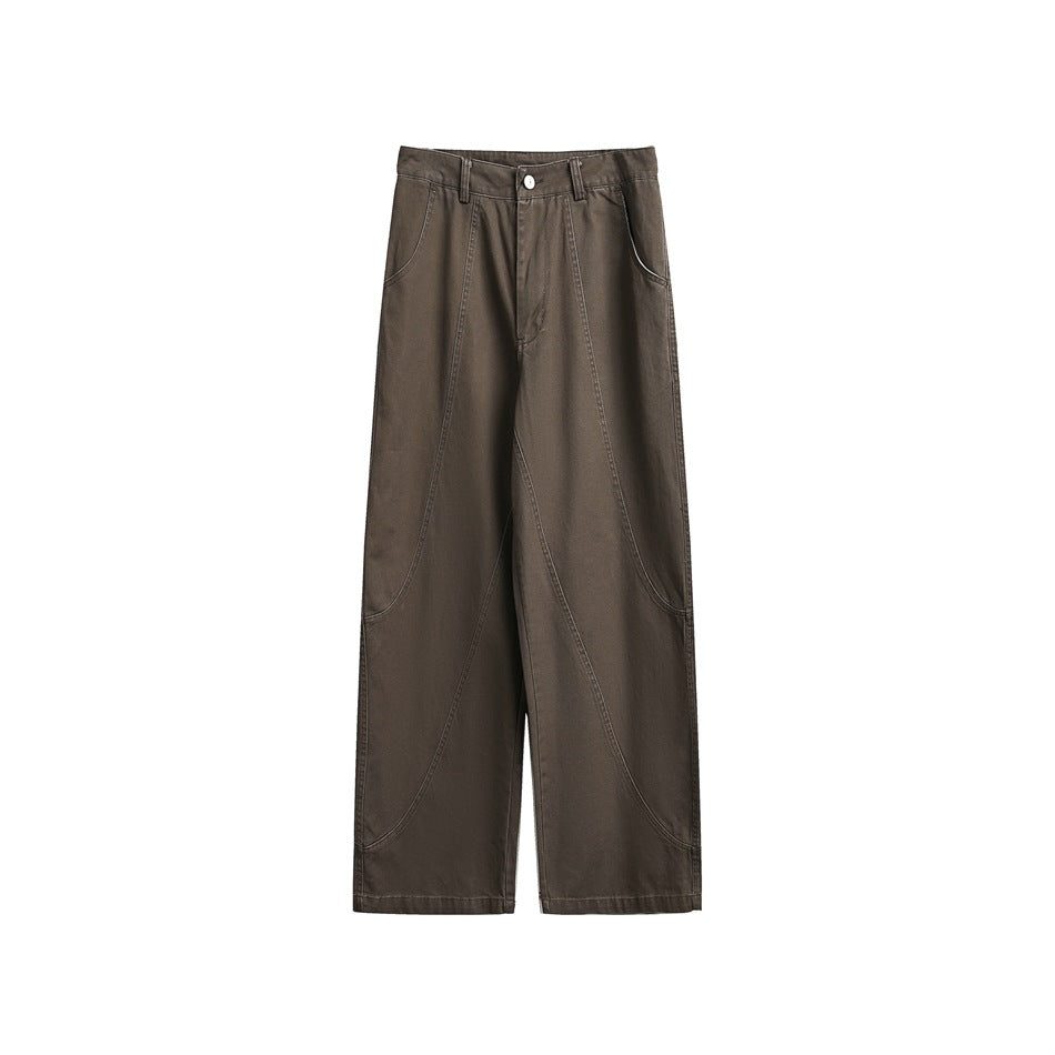 Brown wide-leg pants flat lay with front zip, belt loops, side pockets and curved seam lines down the legs