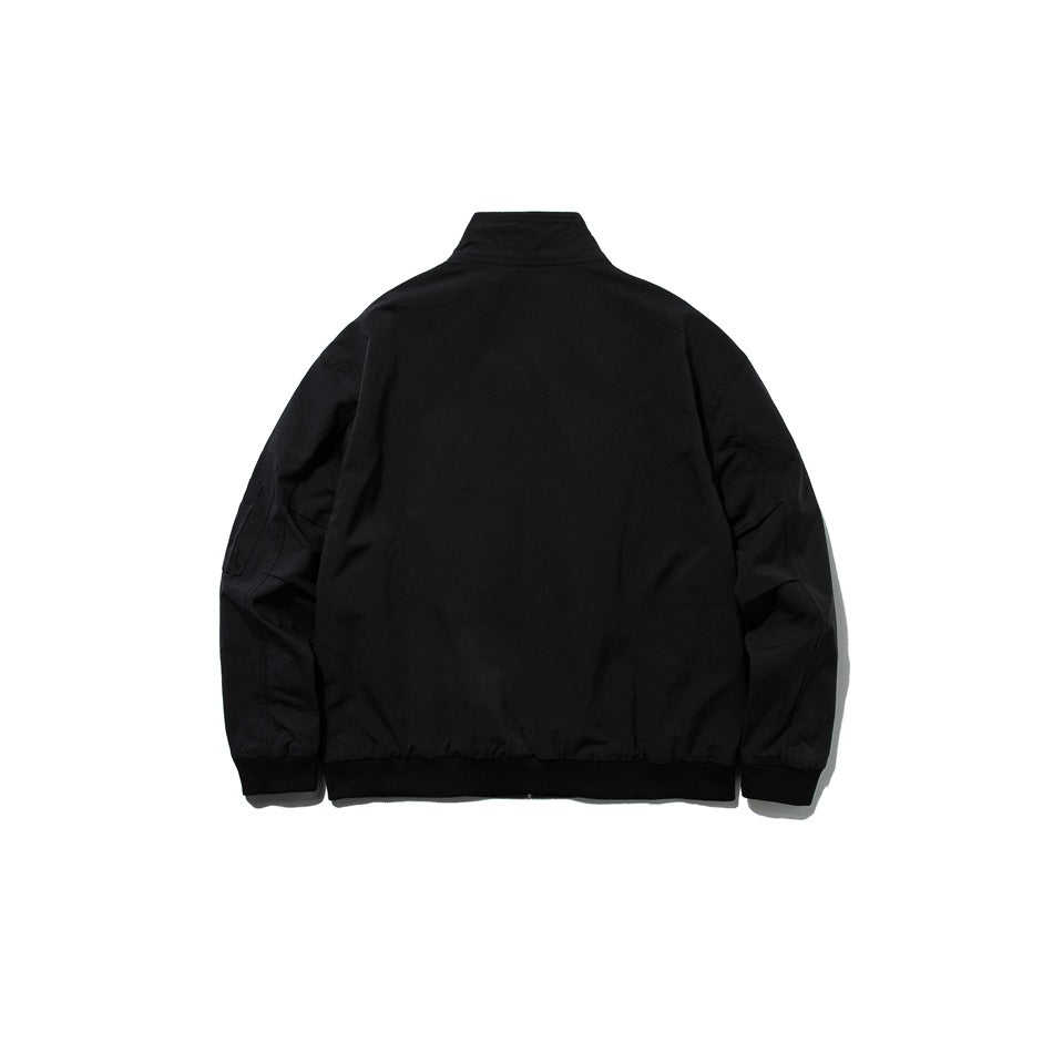 Back view of a black jacket with a raised collar, long sleeves, and ribbed cuffs and hem.