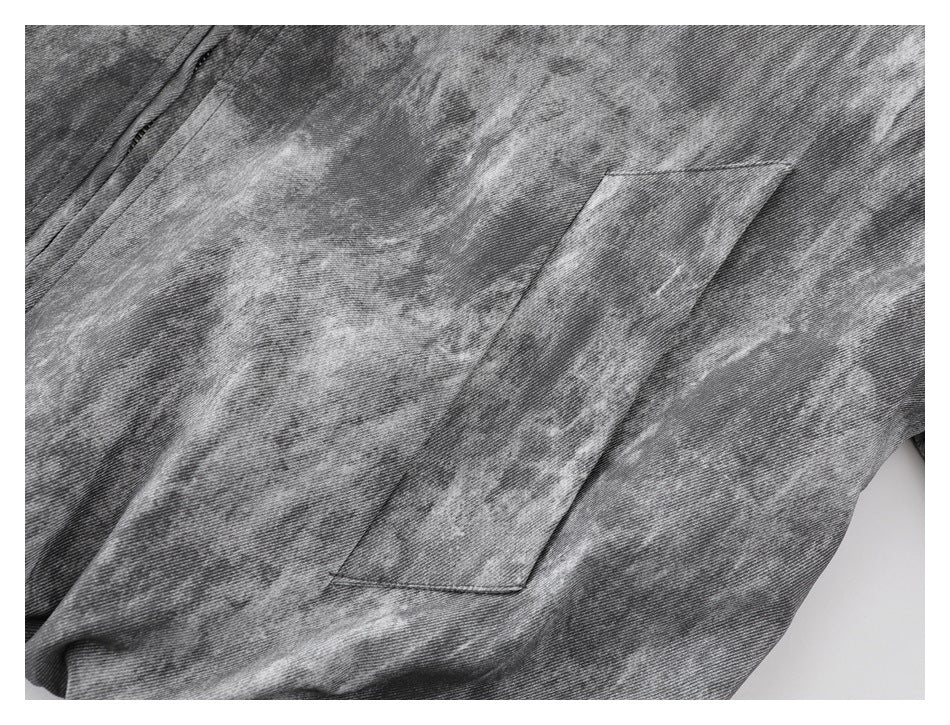 Close-up of a slanted welt pocket on the jacket's gray mottled front.