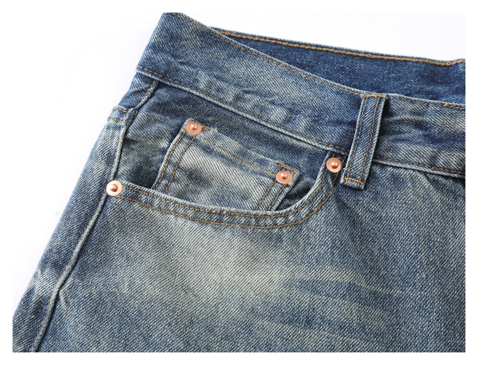 Close-up of the front pocket and small coin pocket with copper-colored rivets and contrast stitching.