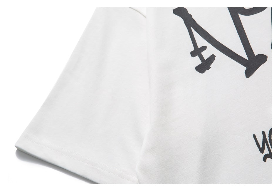 Close-up of a white T-shirt sleeve and chest with a cropped black graphic print.
