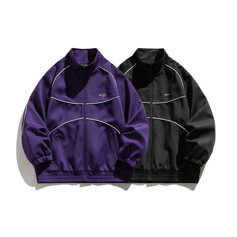 Front view of purple and black zip-up track jackets with white piping and elastic cuffs and hems.