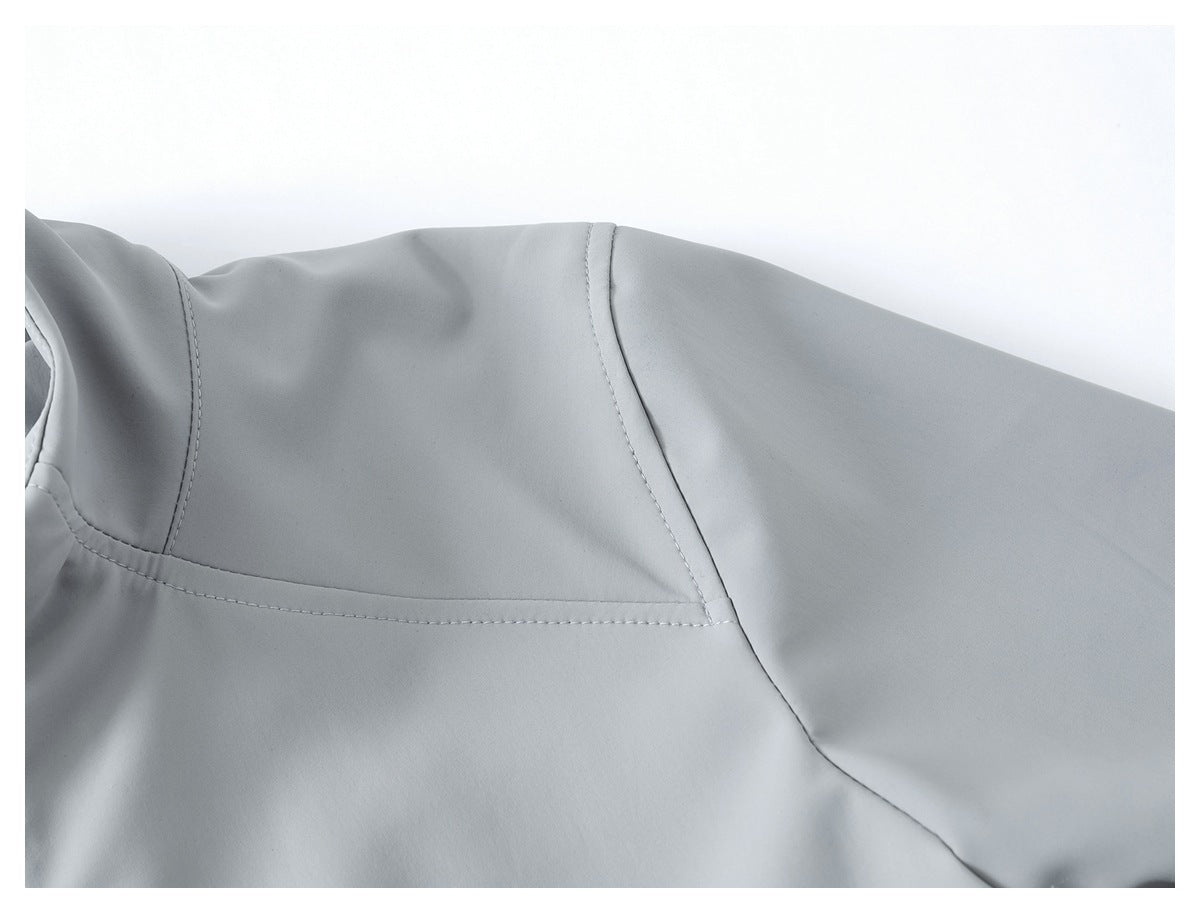 Close-up of a light gray jacket's shoulder and sleeve seam.