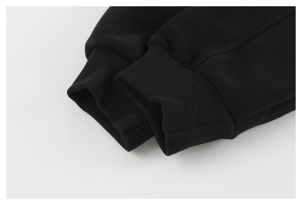 Close-up of the black sleeve ending in a wide ribbed cuff.