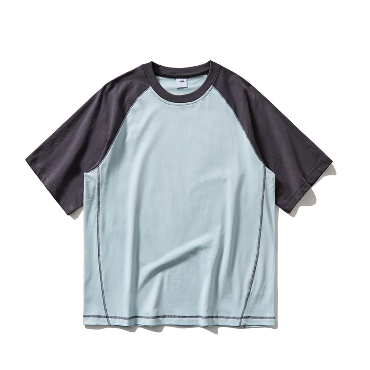 Light blue raglan T-shirt with dark charcoal sleeves and collar and contrast topstitching, flat front view