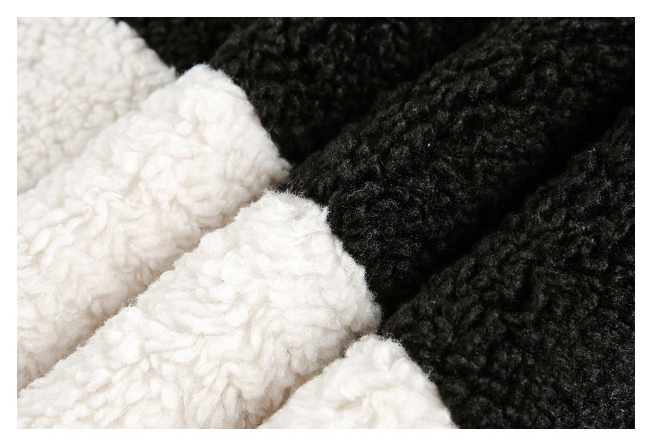 Close-up of curly black and ivory textured fabric in contrasting sections.