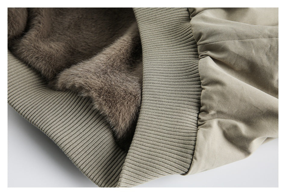 Close-up of brown plush lining beside the jacket's ribbed beige cuff and gathered sleeve.