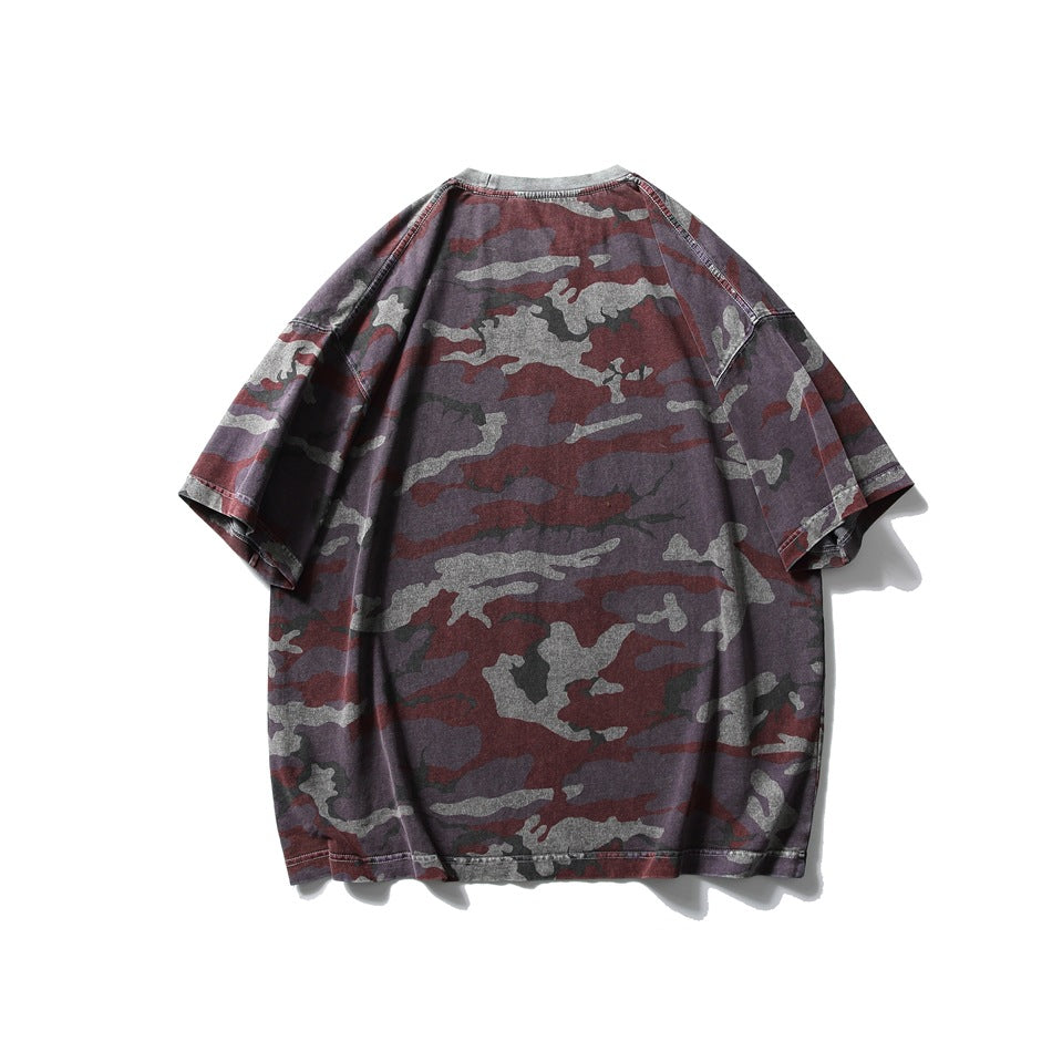Back view of a loose short-sleeve T-shirt in burgundy, charcoal, gray, and muted purple camouflage.