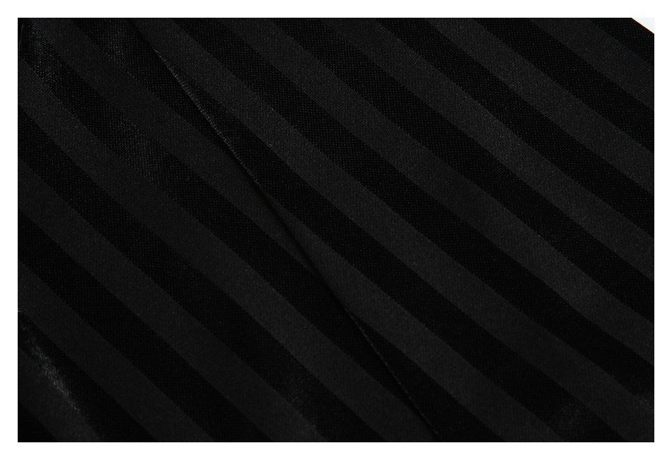 Close-up of black fabric with subtle diagonal tonal stripes and a seam.