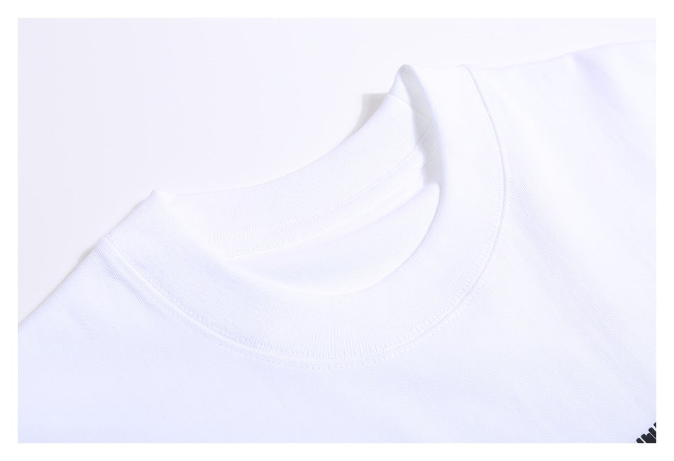 Close-up of the ribbed crew neck and shoulder seam of a white T-shirt.