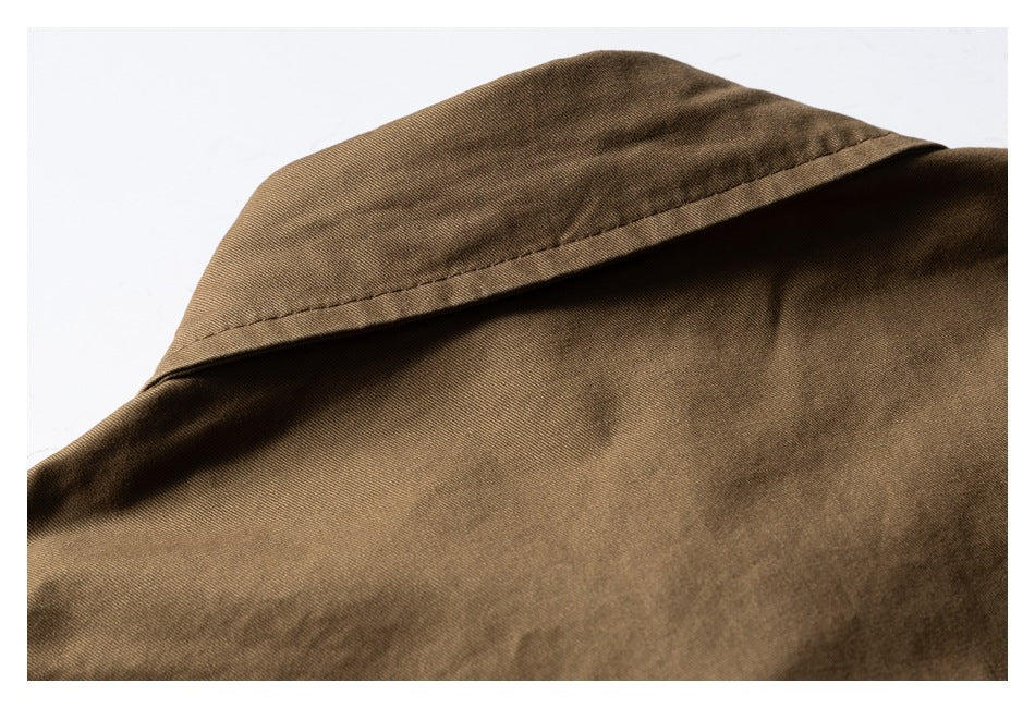Close-up of the collar and upper fabric of a brown shirt.
