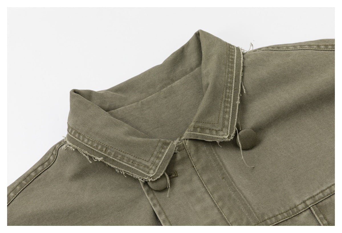 Close-up of the olive-gray jacket's pointed collar, collar stitching, and covered buttons.