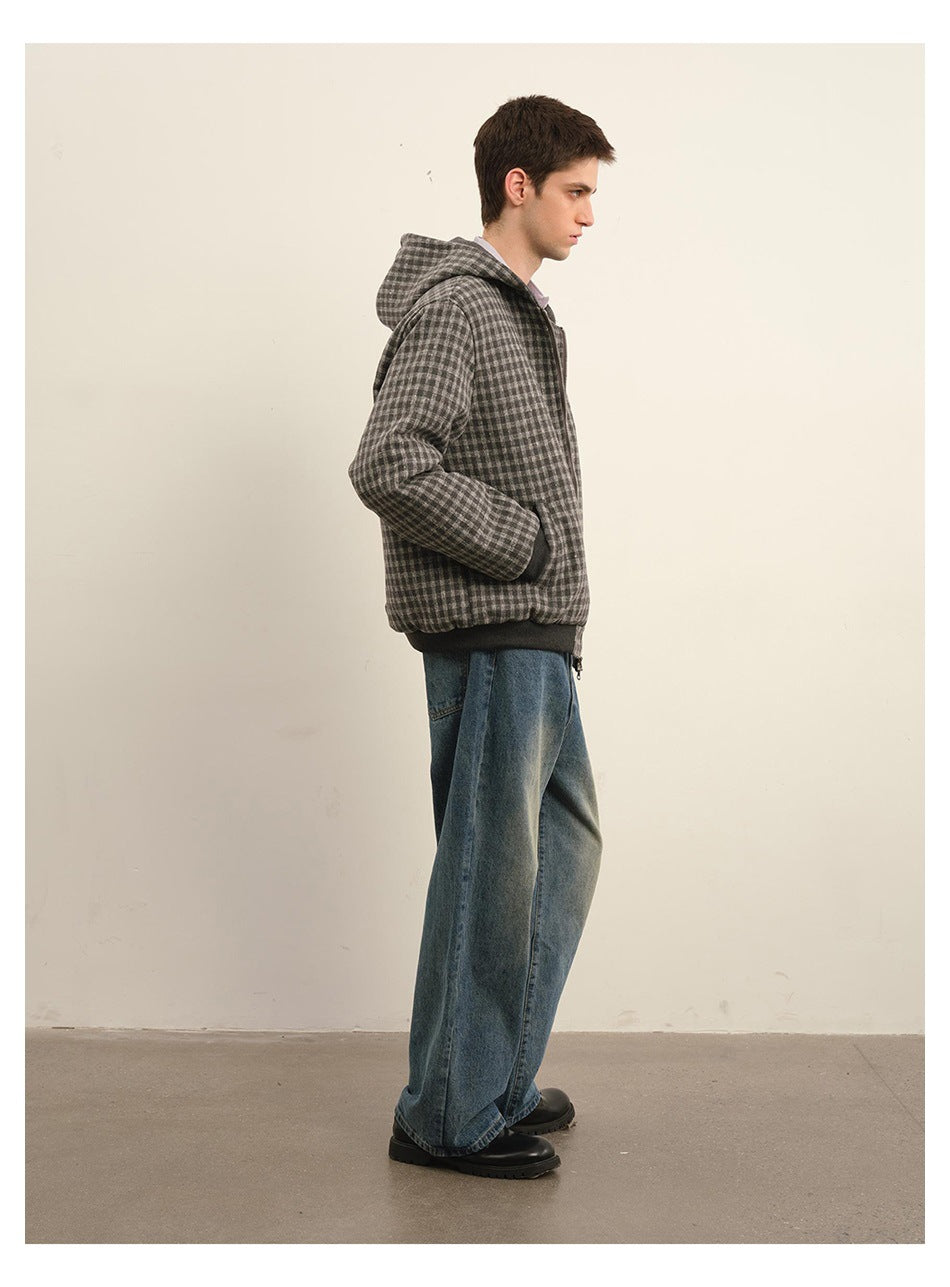 Side view of a model wearing a gray checkered hooded jacket with dark ribbed cuffs and hem.