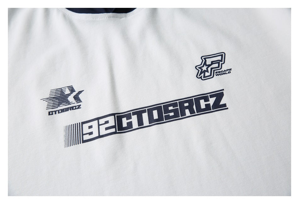 Close-up of navy graphic prints on the chest of a white garment.