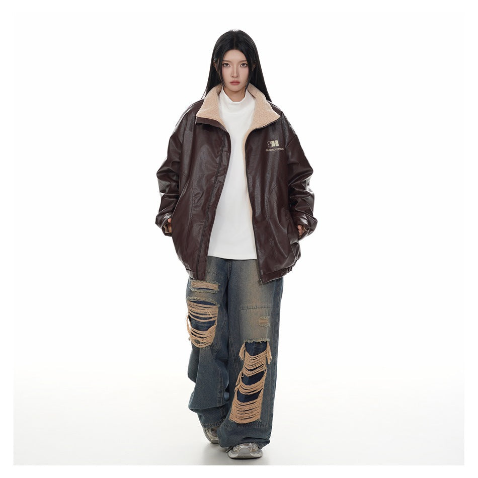 Model wearing an open reddish brown faux-leather-look jacket showing beige fleece-like lining, with white top and ripped