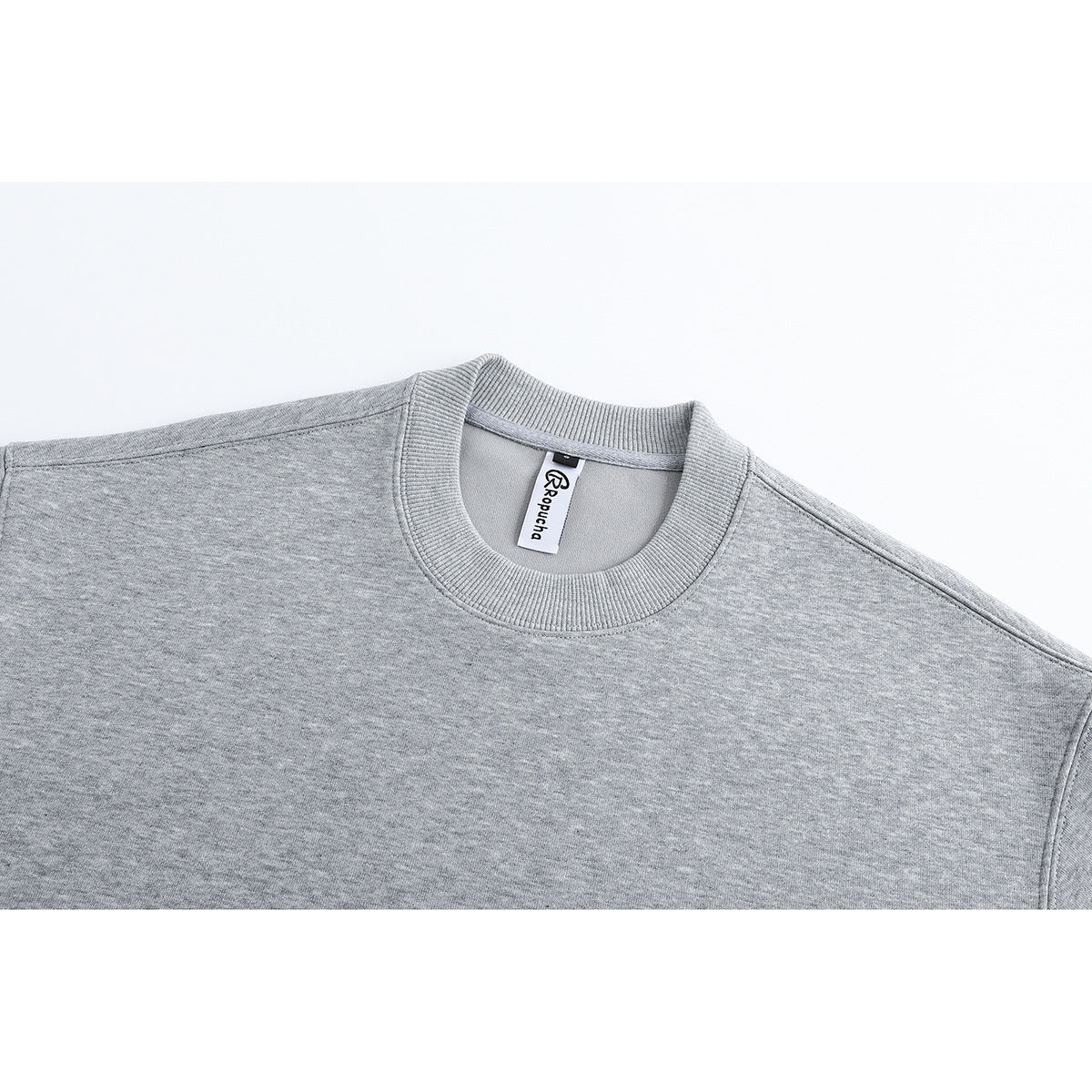Close-up of a heather-gray sweatshirt's ribbed crew neck and sewn-in white label.