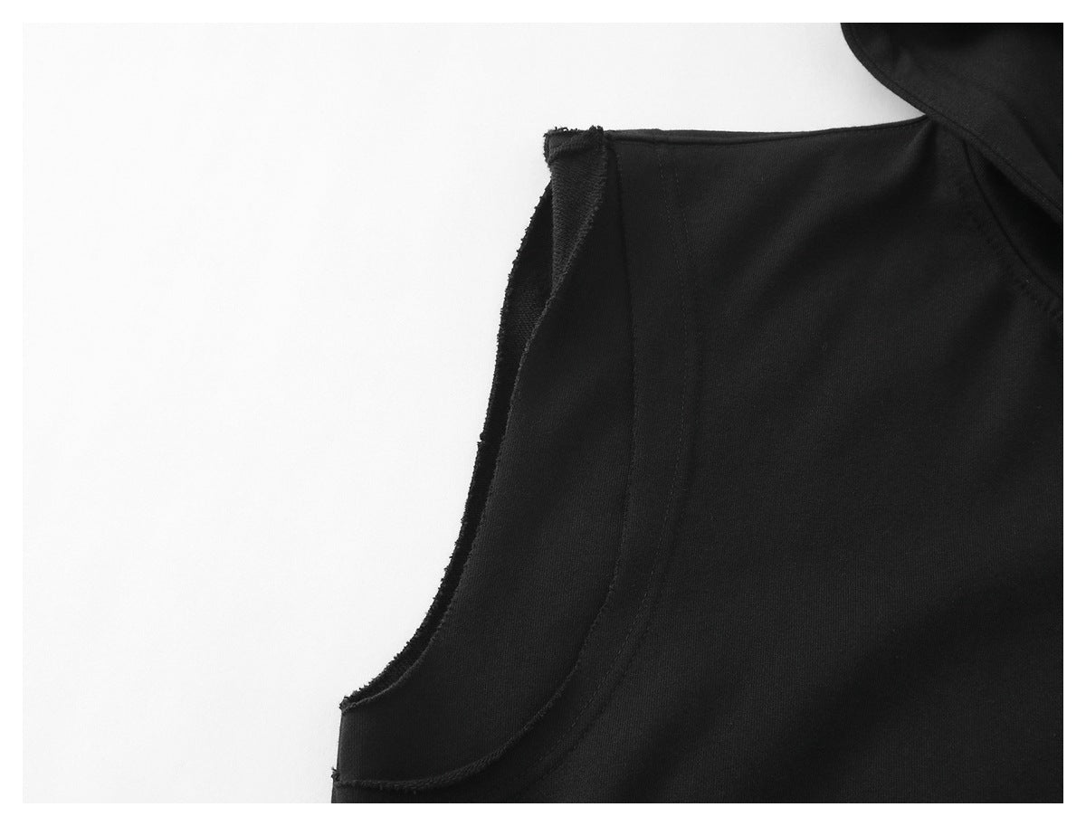Close-up of a black garment's curved armhole opening and stitched seam.