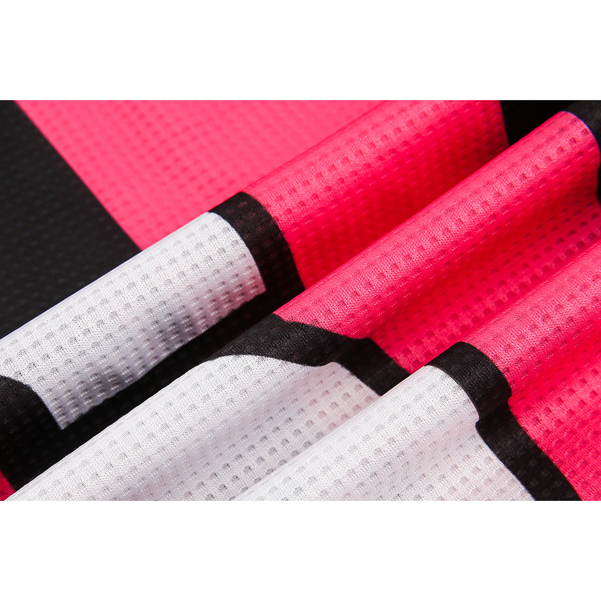 Macro view of black, hot-pink and white sections of textured mesh fabric.