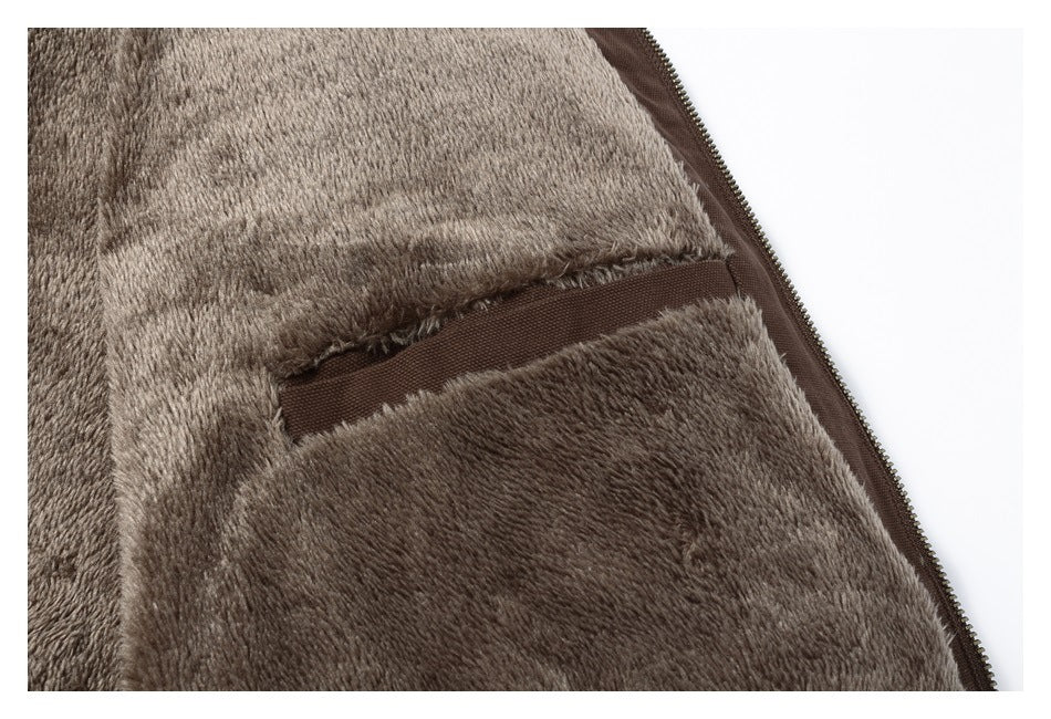 Close-up of the jacket’s plush interior and a small brown-trimmed pocket beside the zipper.