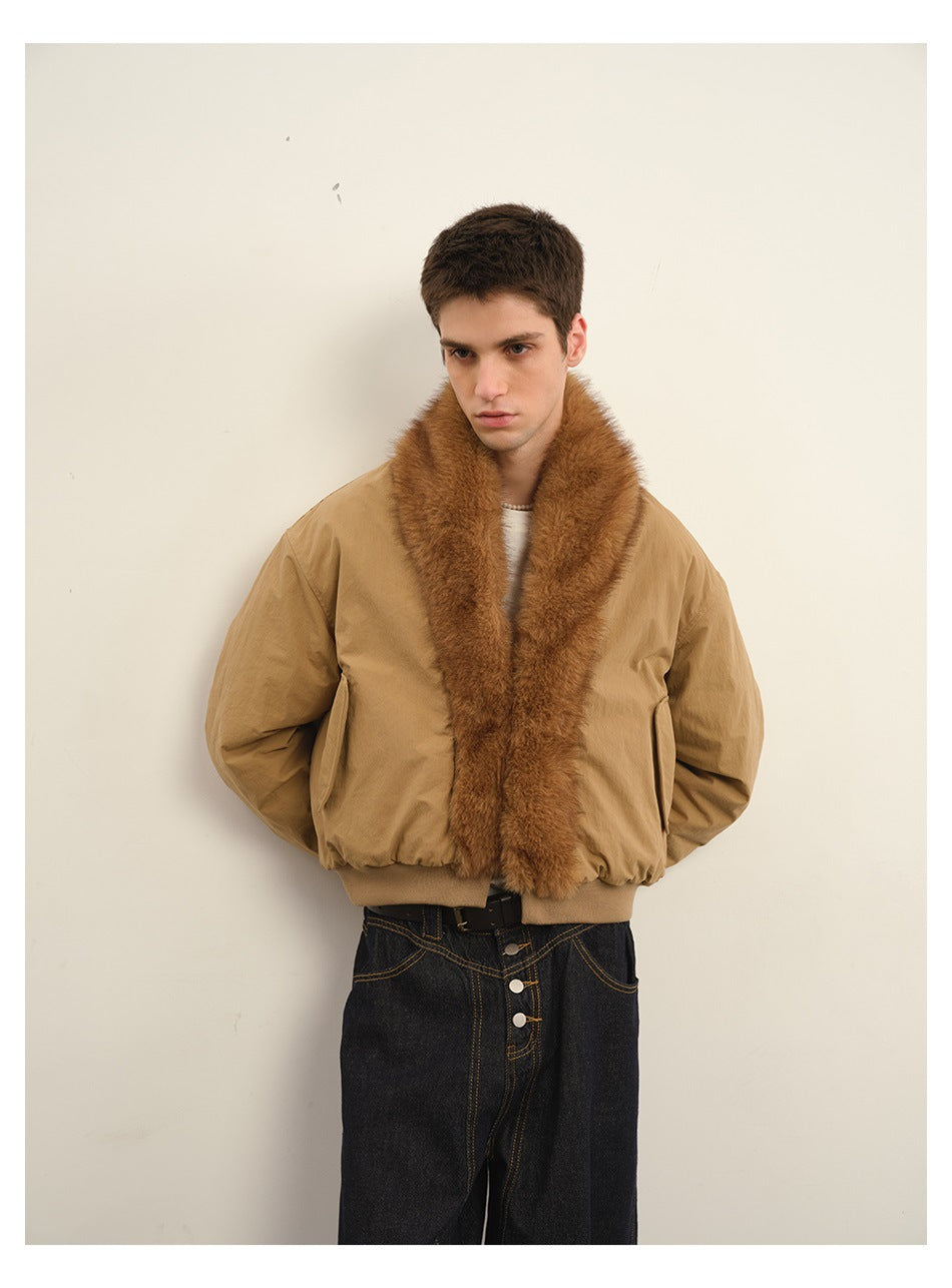 Front view of a model wearing a tan bomber jacket with a plush brown collar and dark jeans.