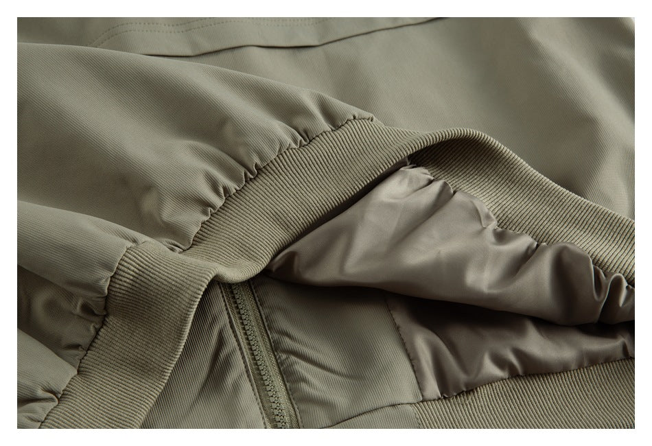 Close-up of the jacket interior, showing smooth lining, a zipper, and ribbed trim.