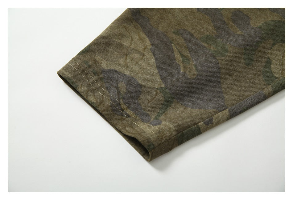 Close-up of the stitched hem on an olive camouflage sleeve.