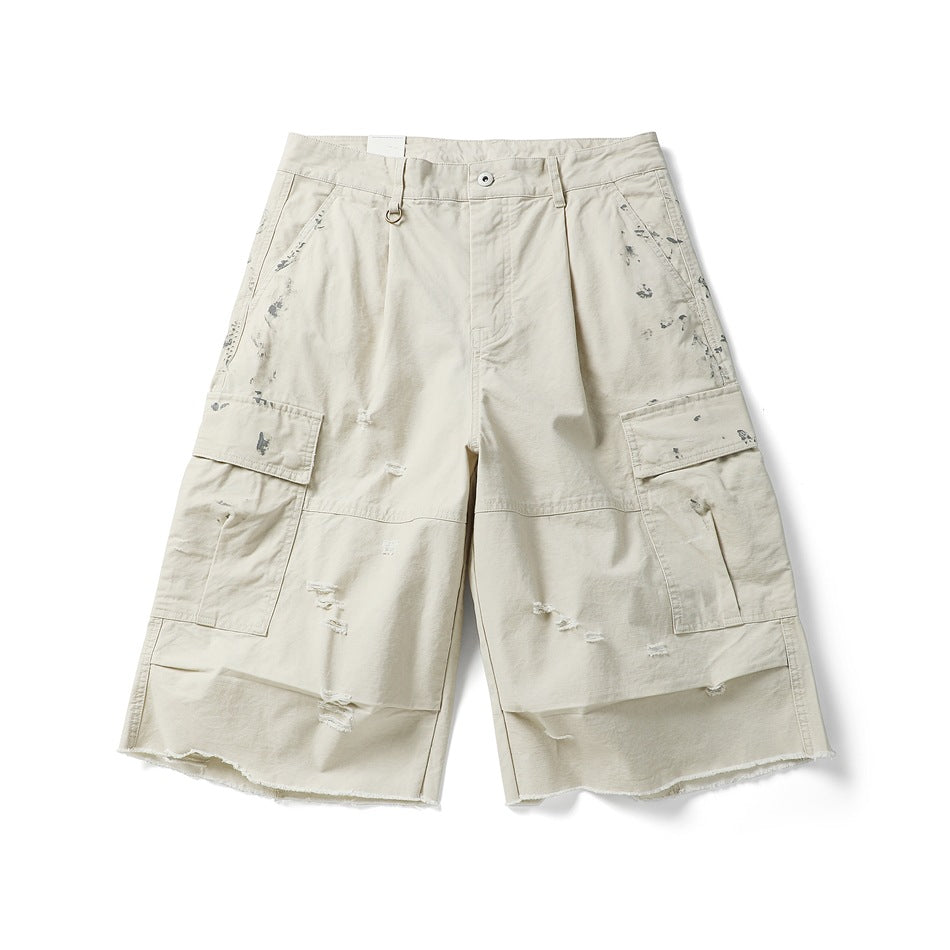 Off-white cargo shorts, front flat lay, with distressed holes, paint splatters, flap pockets and a raw frayed hem