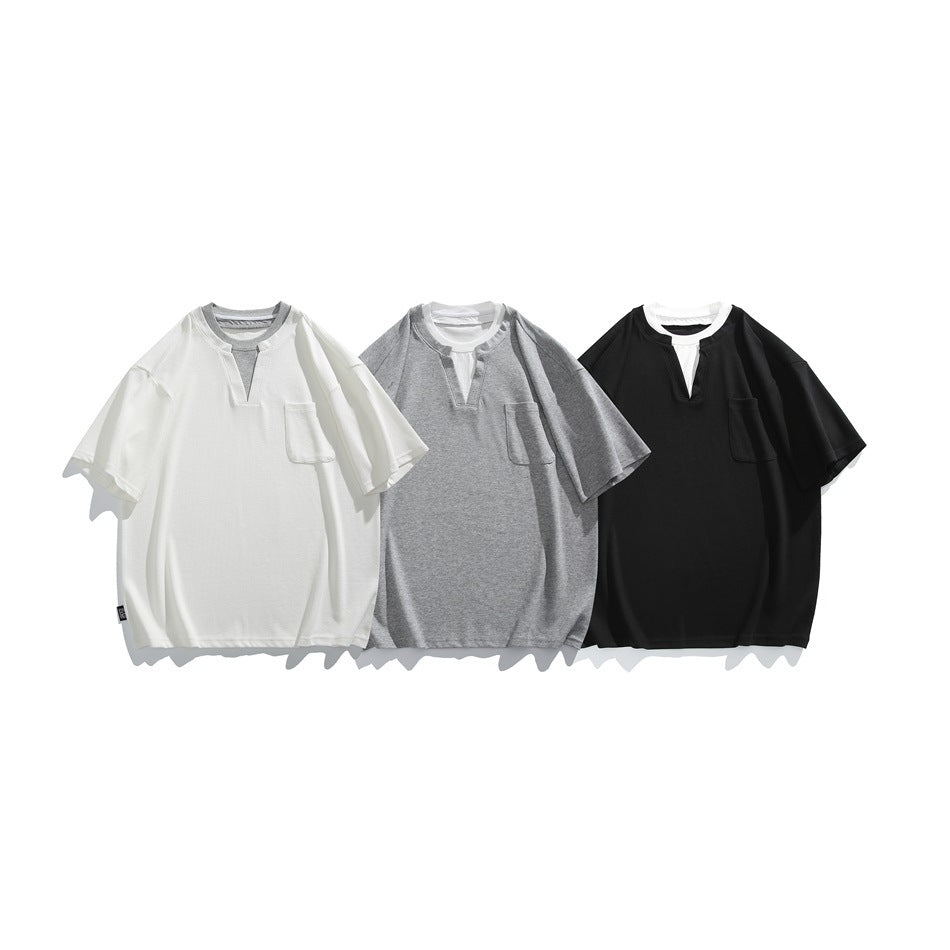 Three short-sleeve shirts with chest pockets and notched necklines in white, gray, and black.