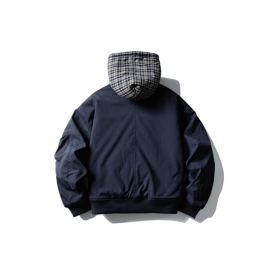 Back view of a navy jacket with a black-and-white plaid hood and ribbed cuffs and hem.