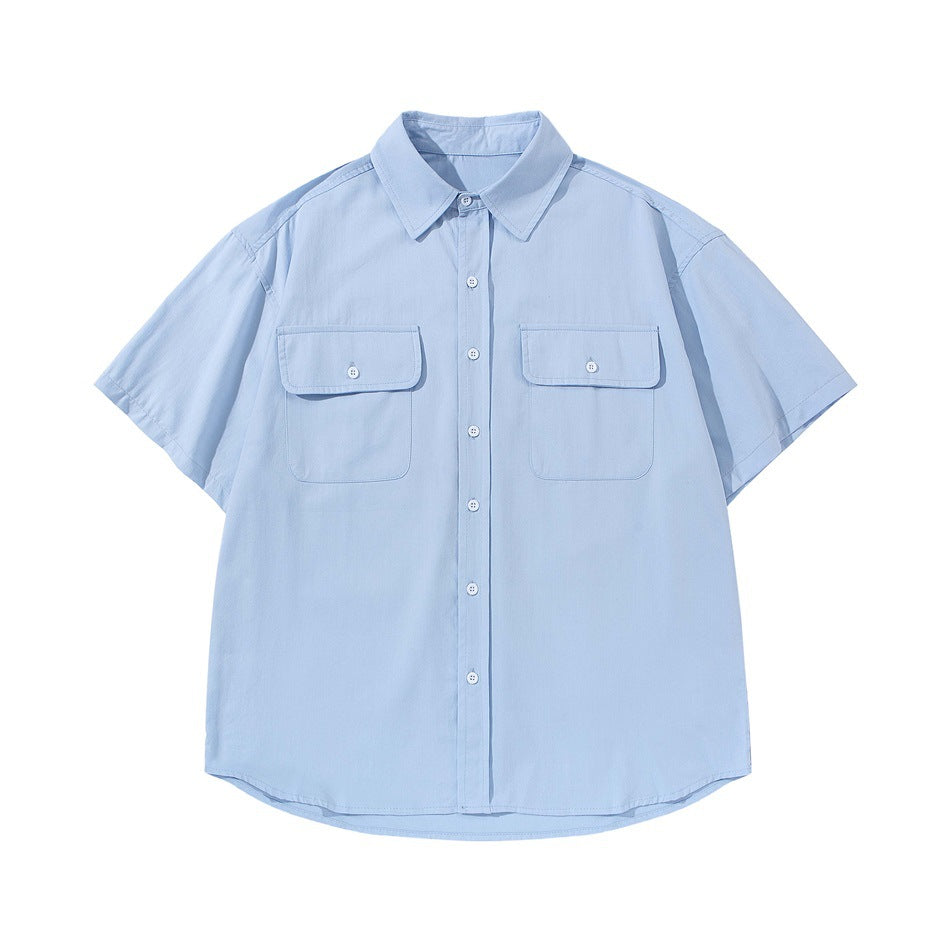 Light blue short-sleeve button-up shirt with two flap chest pockets, flat lay front view
