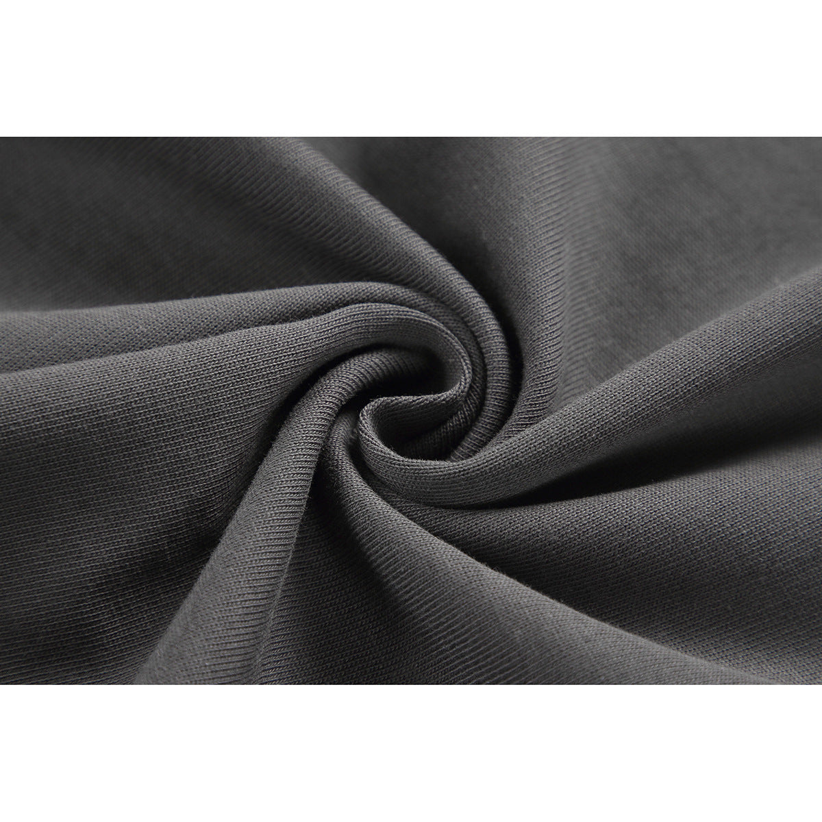 Macro view of charcoal fabric gathered to show its surface texture.