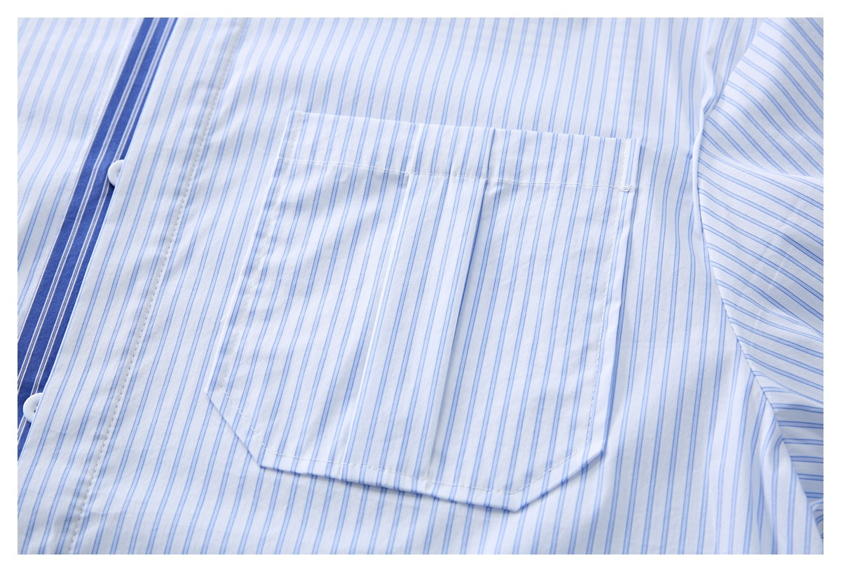 Close-up of a white shirt with fine blue stripes, showing a chest pocket and part of the button placket.
