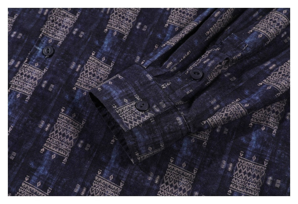 Close-up of dark buttons and a buttoned cuff on a navy garment with tan geometric patterns.