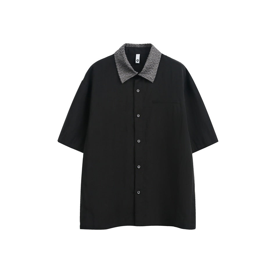 Black short-sleeve button-up shirt with gray textured collar and chest pocket, flat front view