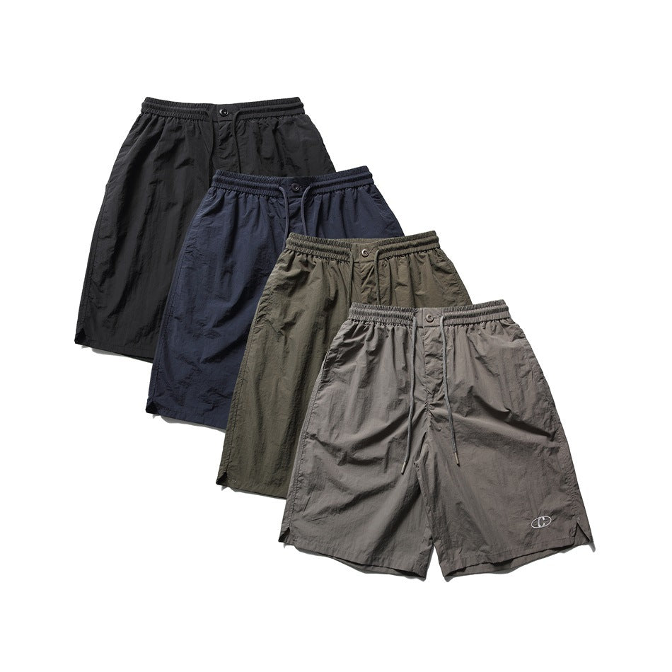 Four pairs of loose shorts shown from the front in black, navy, olive, and gray.