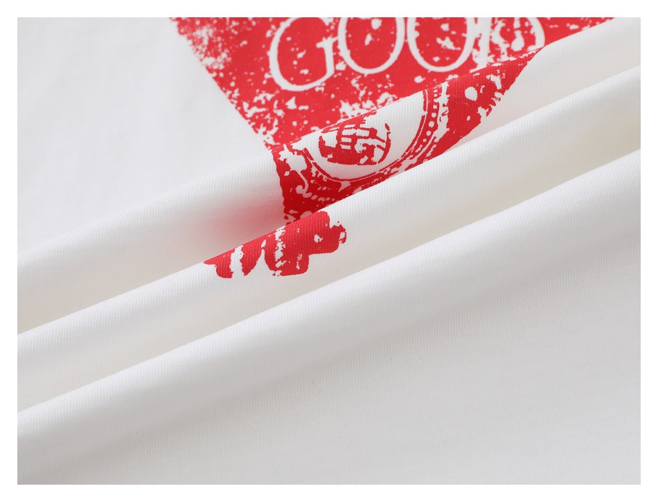 Close-up of white fabric with a distressed red graphic print and partial lettering.