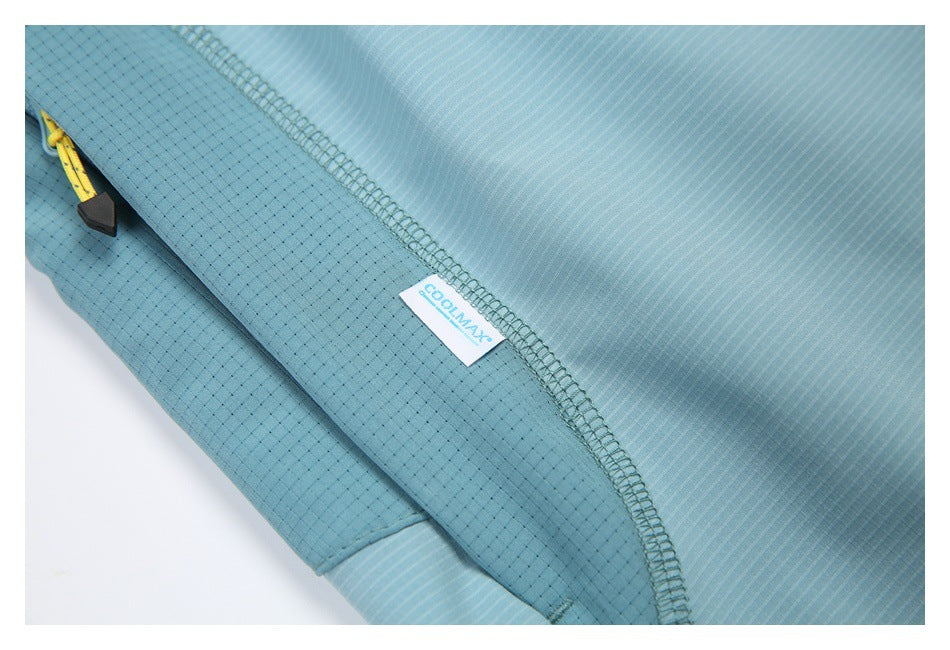 Close-up of blue shorts showing a yellow pocket zipper, stitched seam, and small COOLMAX label.