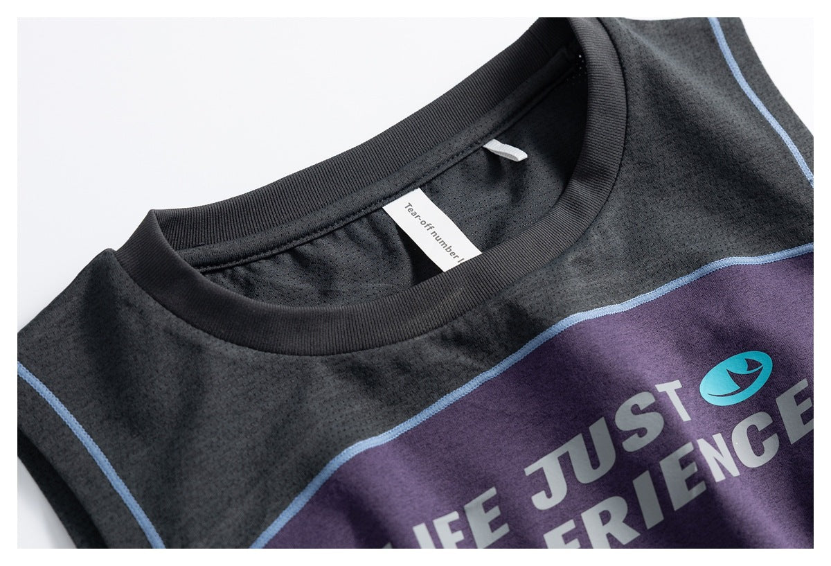 Close-up of the black ribbed neckline, mesh-like black panel, blue piping, and purple printed front of a sleeveless top.