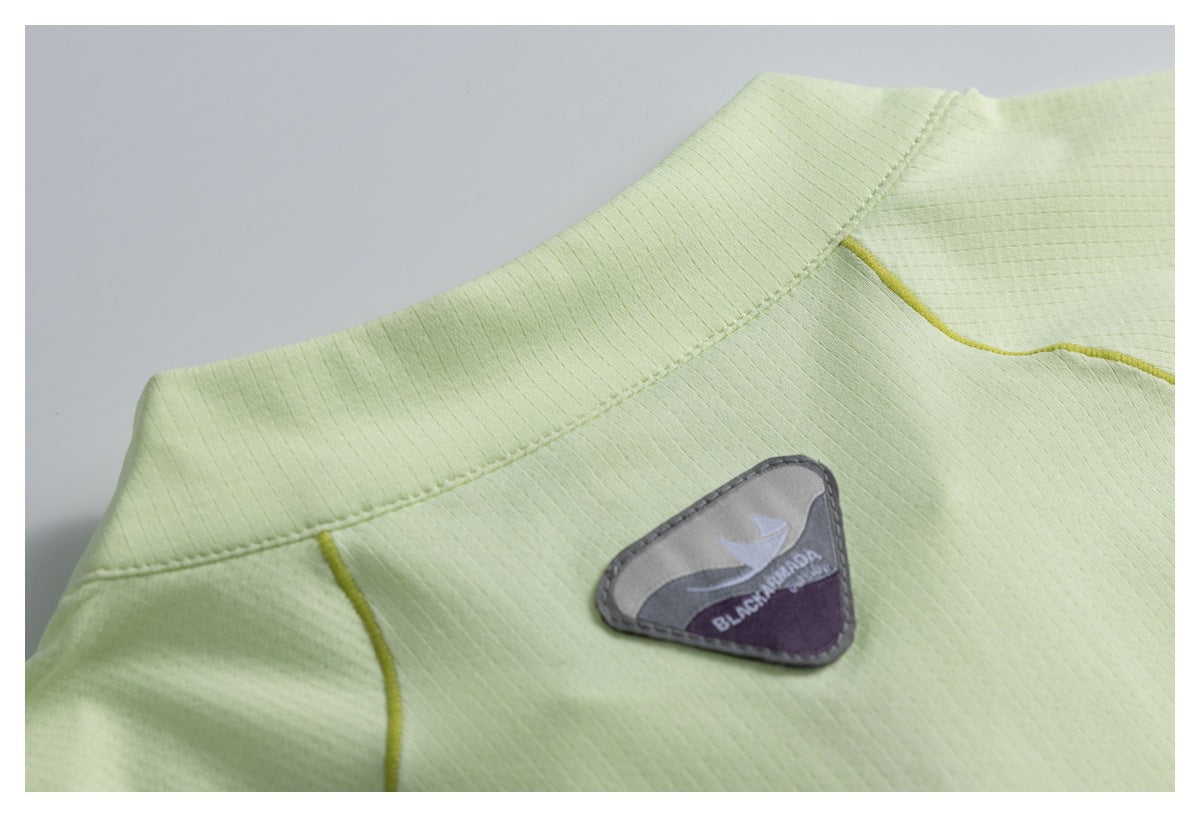 Close-up of a pale lime stand collar and a sewn gray-and-purple brand patch.