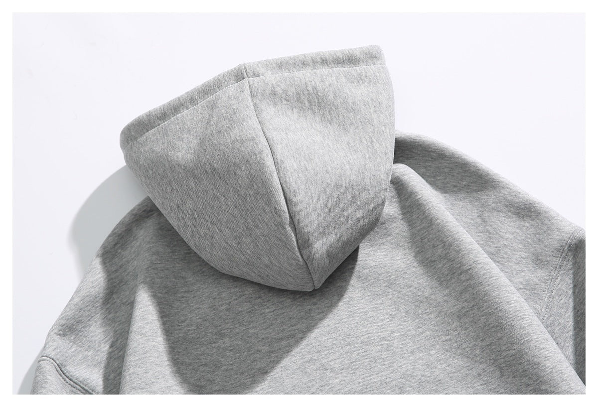Close-up of the back of the gray hoodie’s hood and shoulder seams.