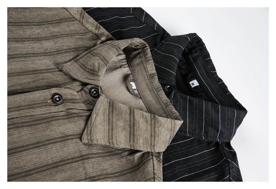 Close-up of the collars and buttons on overlapping taupe and black striped shirts.