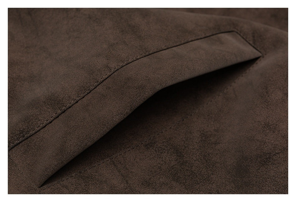 Close-up of a dark brown garment pocket opening with a stitched edge.