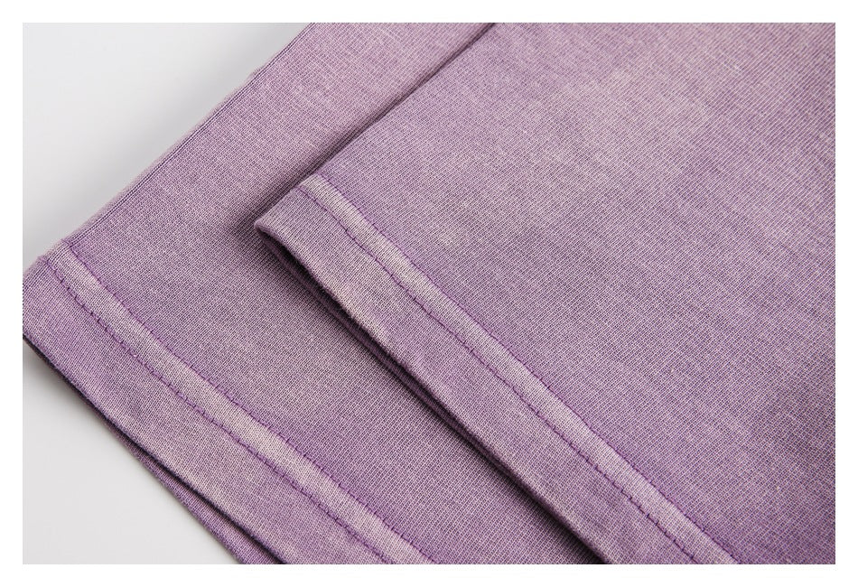 Close-up of folded lavender garment edges with stitched hems.