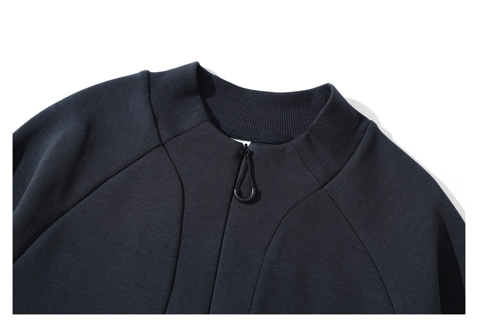 Close-up of the dark navy sweatshirt's ribbed stand collar and short front zipper with a loop pull.