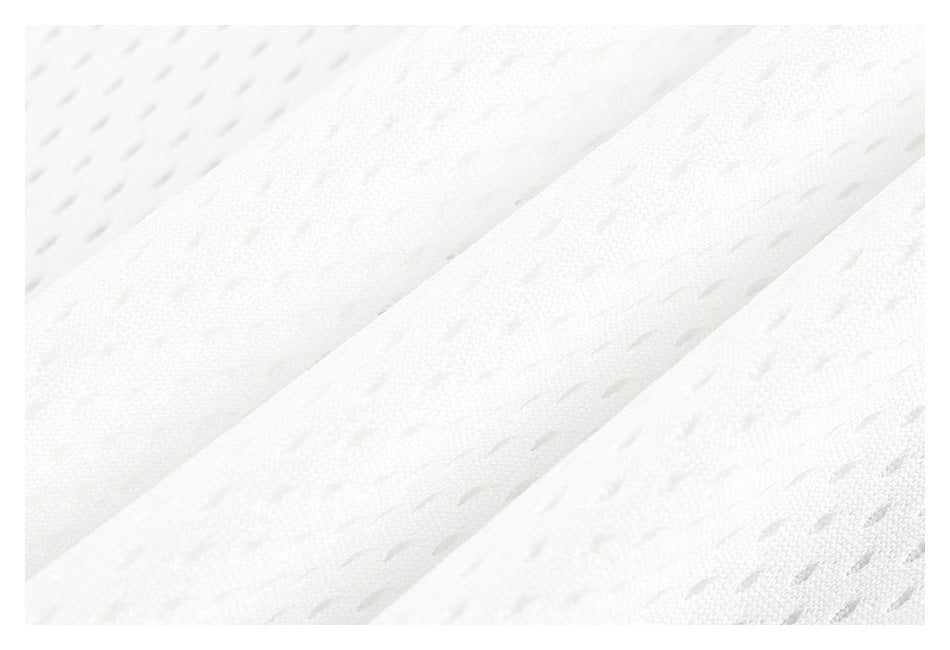 Macro view of white garment fabric folds and perforated mesh texture.