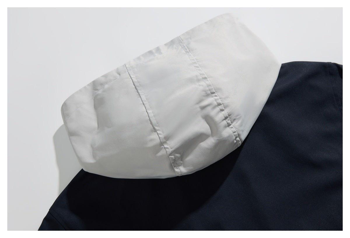 Close-up of the pale lined hood resting against the dark navy body of a garment.
