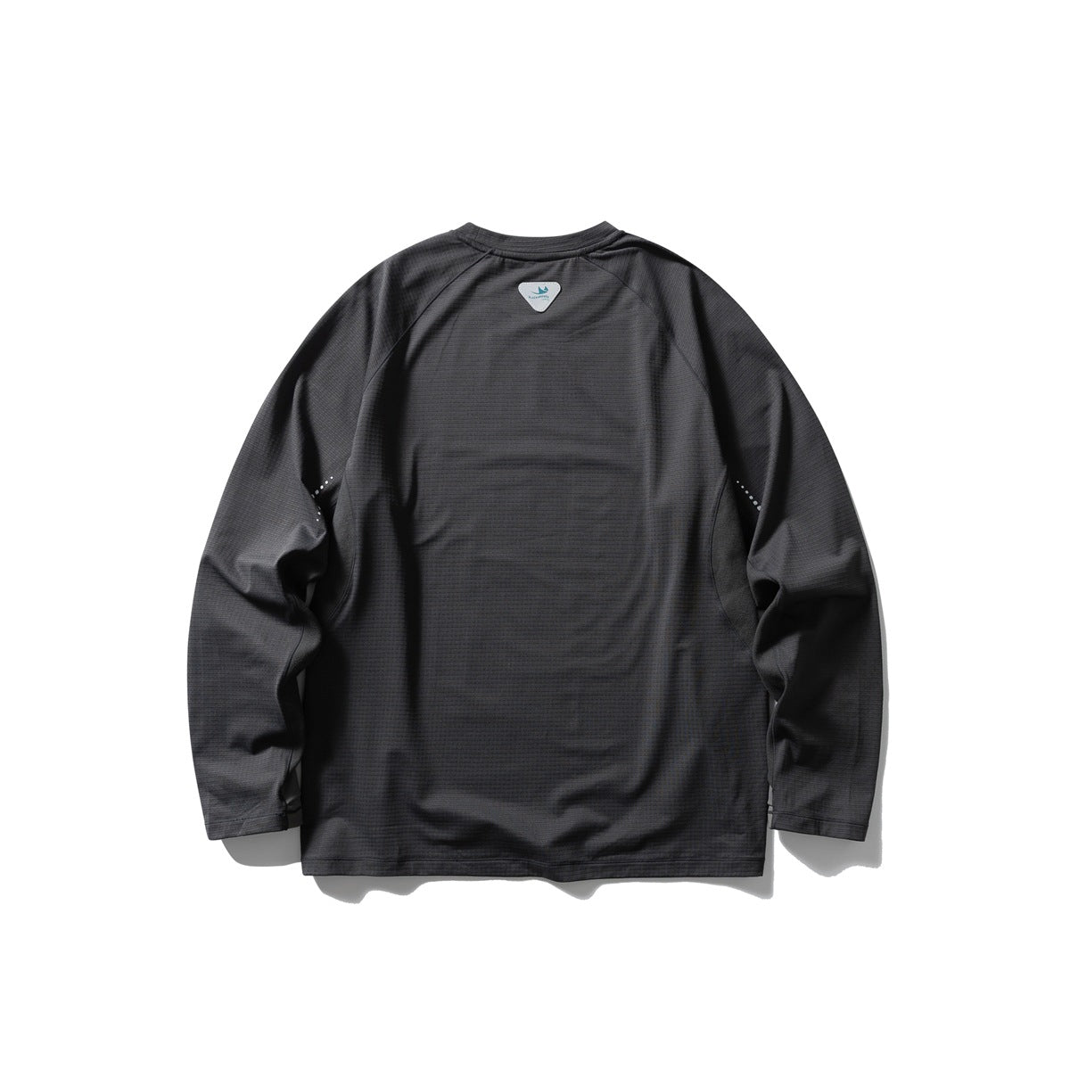 Back view of a charcoal long-sleeve raglan shirt with a small upper-back patch and reflective sleeve dots.
